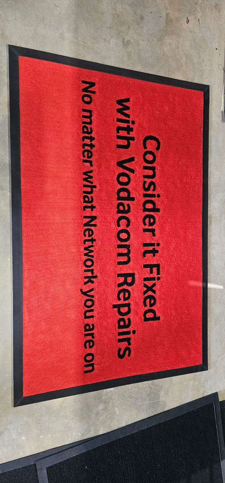 Framed branded print signage for an indoor corporate space