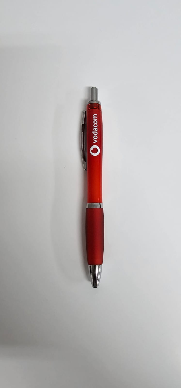 Red branded promotional pen shown on a neutral background