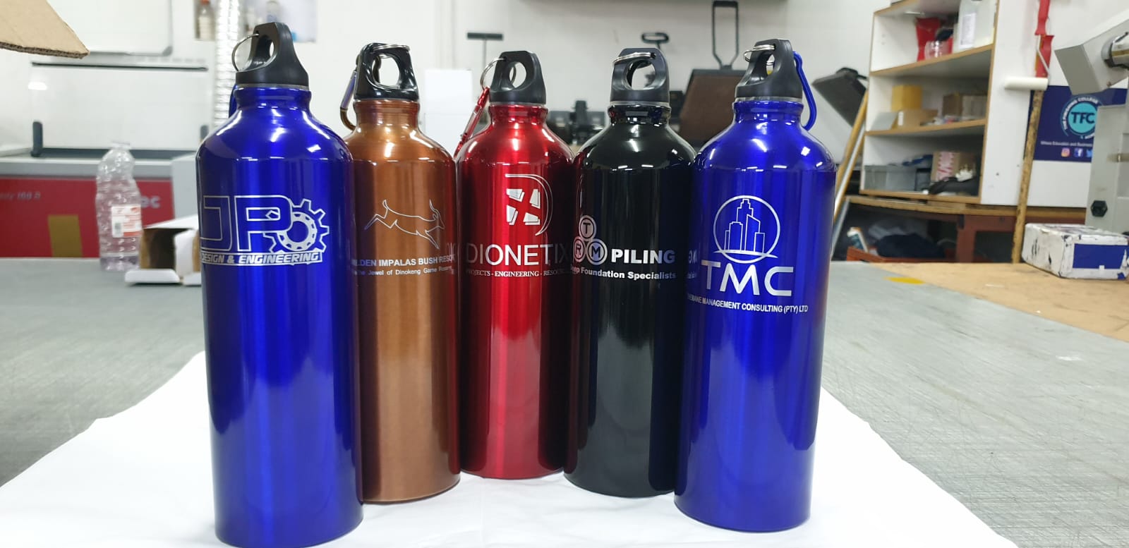 Assorted branded metal water bottles in multiple colours